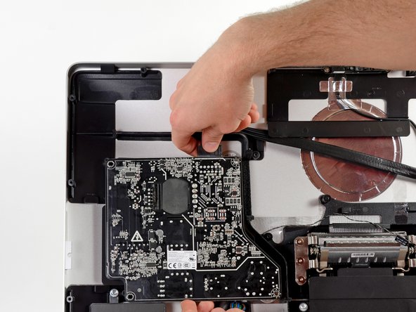 Image 2/3: We make quick work of them and the Flextronics power supply board comes free.