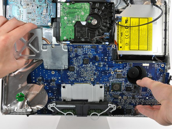 Image 2/2: Do not completely remove the logic board as the DC power cable connector is still connected to the underside of the board.