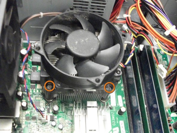 Image 1/1: Locate and unscrew the four Phillips #0 screws at the corners of the fan.