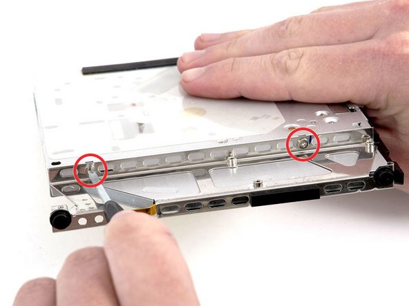 Image 1/1: Remove the bracket from the optical drive.