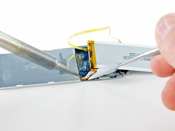 Image 2/3: Once the three connections have been desoldered, lift the old battery off the logic board.