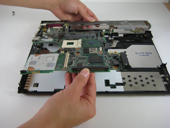 Image 1/1: Lift the entire motherboard assembly out of the case.