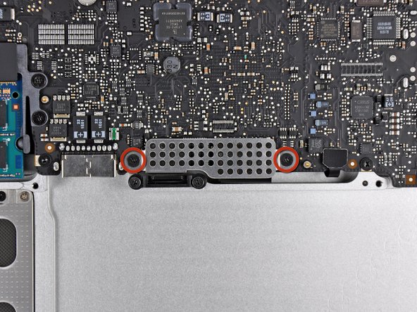 Image 1/2: Remove the EMI shield from the logic board.