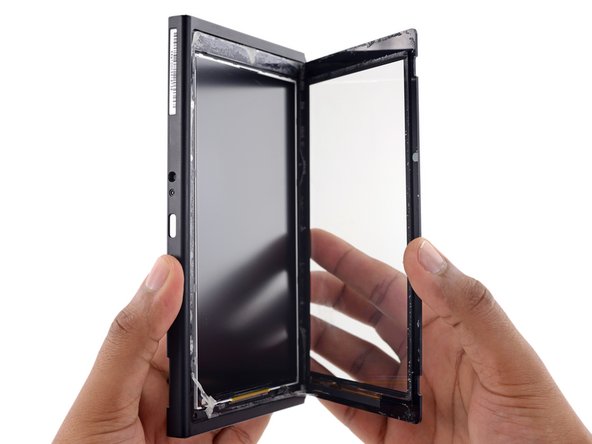 Image 3/3: But in all our excitement, our hasty teardowner severed the digitizer data cable. Fixers be warned, this book opens longways.