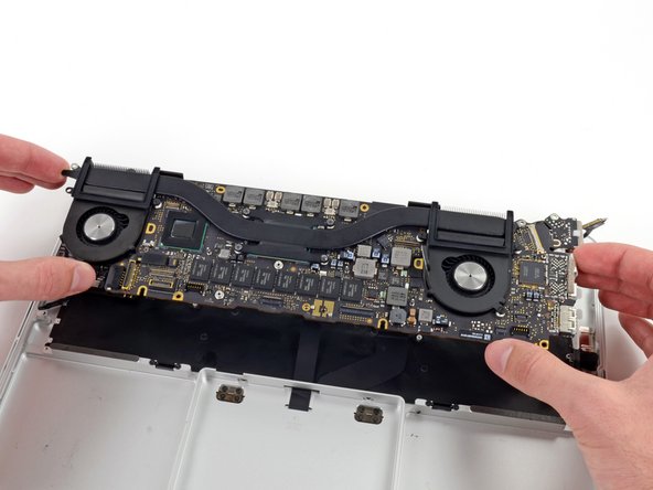 Image 2/2: Pull the right I/O port side of the logic board away from the side of the upper case and remove the logic board assembly.