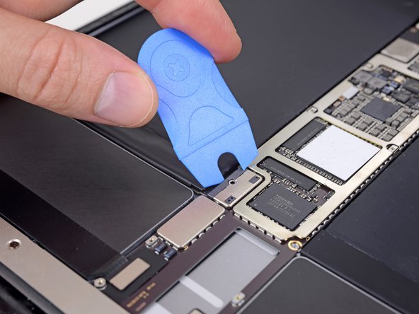 Insert a Battery Blocker or other insulator underneath the logic board to separate it from the battery connector.