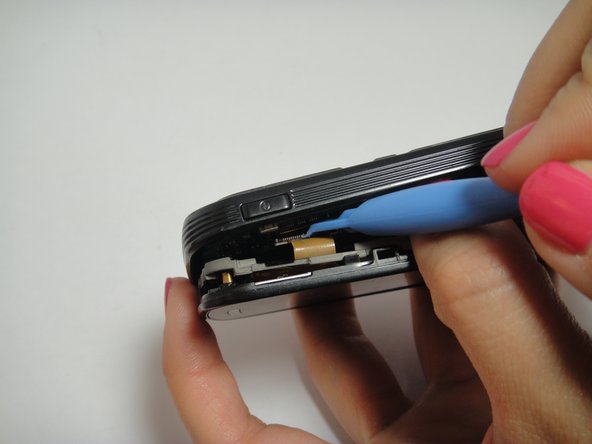 Image 3/3: Carefully disconnect ribbon cables and slowly lift the inside back cover to remove it.