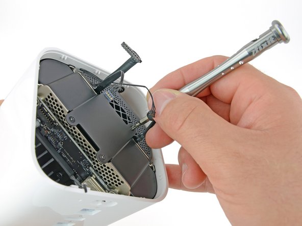 Image 2/2: We begin to free the internals with a flick of the spudger and a twist of the Torx screwdriver. The non-proprietary T8 Torx screws come out with ease.