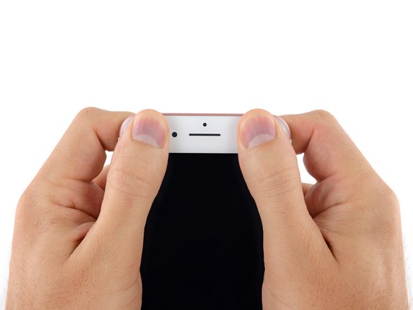 Remove the books and use your fingers to press firmly on all four corners of the display.