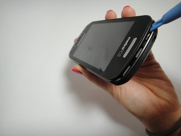 Image 1/3: Place the Plastic Opening tools on the outside rim of the inside back cover.