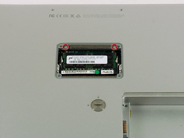 Image 1/1: Remove the two 12 mm Phillips screws on the Aluminum bracket at the top of the memory compartment.