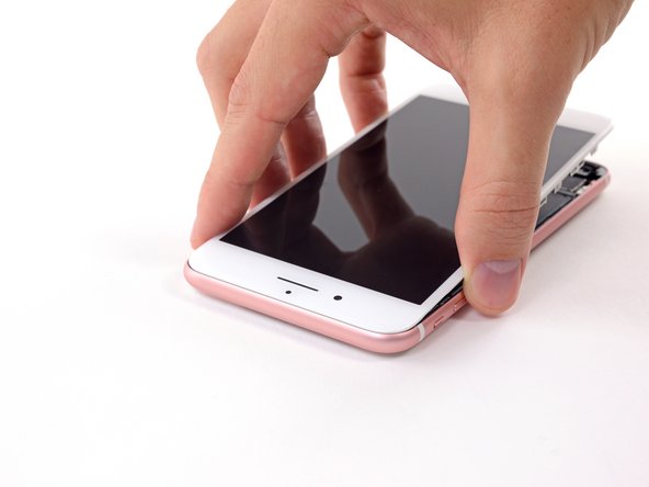 Position the display so that the tabs along the top edge fit into place just underneath the top edge of the iPhone's case.