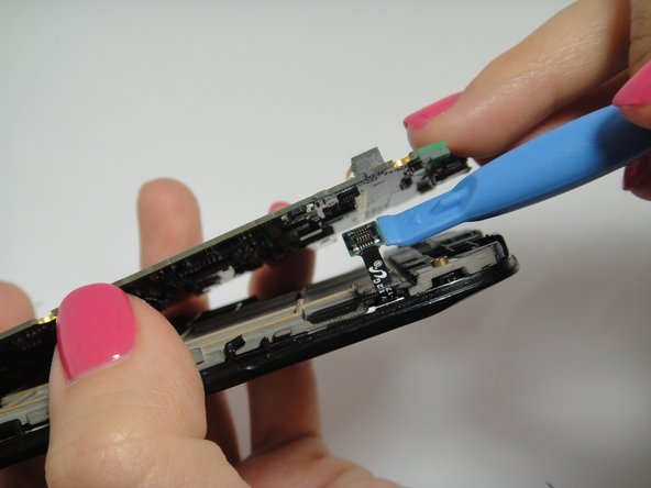 Image 2/3: Pull back the side clips and lift the motherboard slowly.