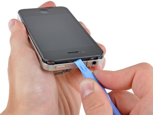 Image 2/2: Carefully pry the upper edge of the front panel assembly away from the steel inner frame.