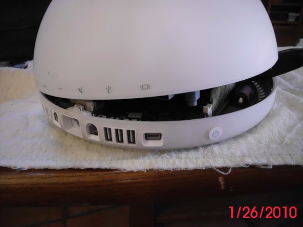 Image 2/2: Set the unit on it's base, grasp the neck and tilt it to separate the base.