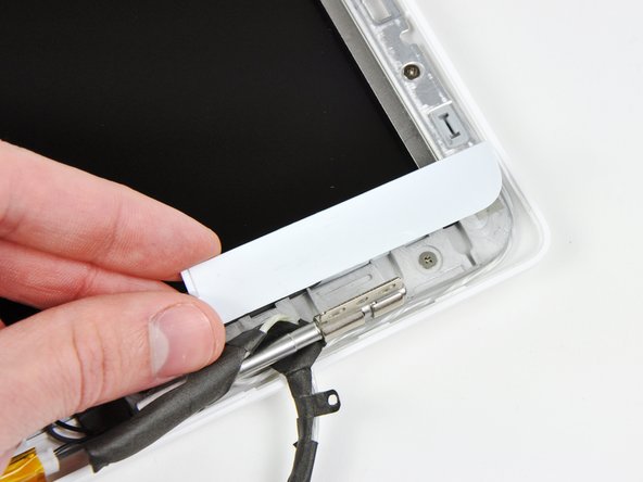 Lift the right bezel cover off the display assembly.