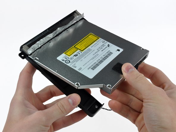 Image 2/3: Pull the optical drive bracket away from the open end of the optical drive, minding any tabs that may get caught.