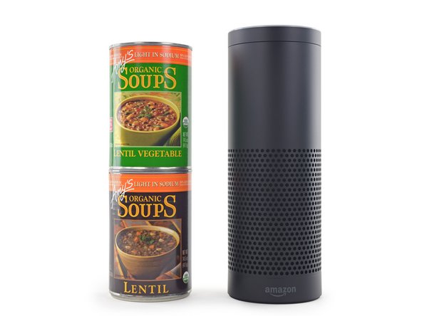 The Amazon Echo standing just taller than two cans of soup