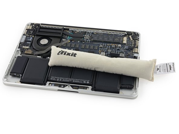 Image 2/2: After about a minute, reheat the iOpener and move it to cover the other half of the right-most battery cells.