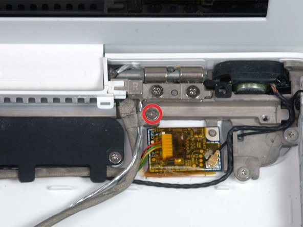 Remove the single 3.2 mm Phillips screw securing the ground loop in the display data cable located just above the Bluetooth board.