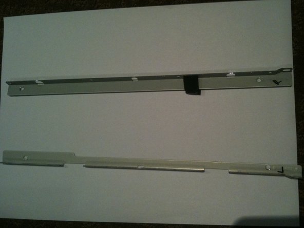 Image 3/3: Use a T10 Torx driver to remove the 2 screws from each side bracket (total 4 screws)