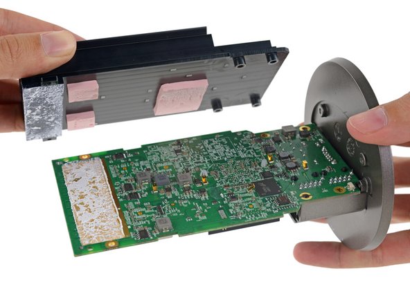 Image 2/3: The components in this thing have been pretty big so far, and the heat sink is no different. Prying up the metal mass reveals some equally hefty thermal pads.