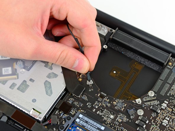 Image 1/1: Don't lift upward on the camera cable as you disconnect it. Pulling upward on the cable may damage both the cable and the logic board. Pull the cable parallel to the face of the logic board.