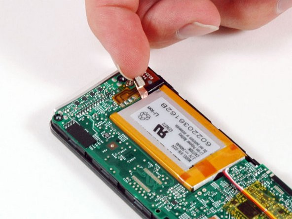 Peel up the ground strap connecting the battery to the logic board.