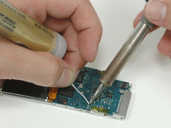 Place the soldering iron onto the battery wire and metal connector for one to two seconds to heat them up.