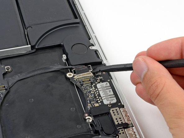 Image 2/2: Do not lift up on the I/O board data cable, as its socket is very fragile. Pull the cable parallel to the face of the logic board.