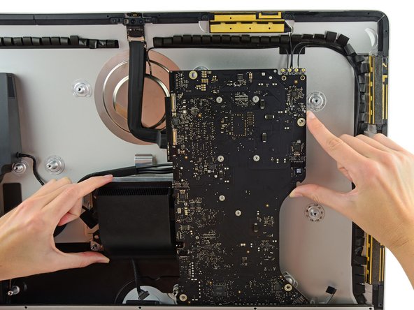 Image 2/3: Be careful '''not''' to snag the board on any of the rear case's screw posts.