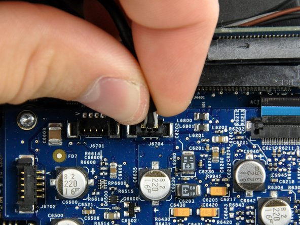 Image 1/1: During reinstallation, ensure that the mic cable runs between the ODD fan and the board support.  If the cable runs on the wrong side of the support,  the cable will be too short to plug in.