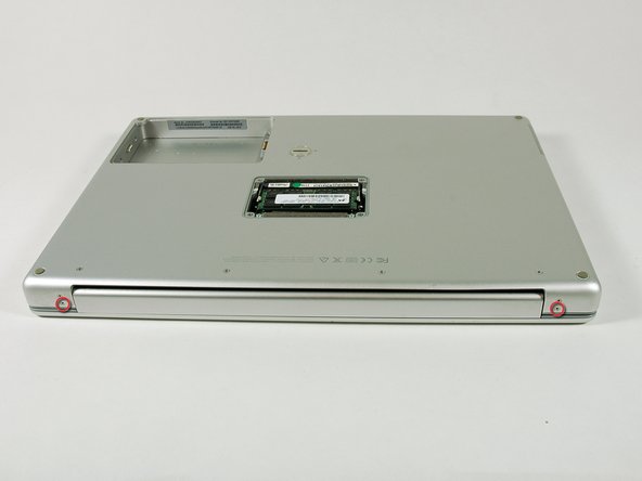 Image 1/1: Remove the lower 5 mm Phillips screw on each side of the hinge (two total).