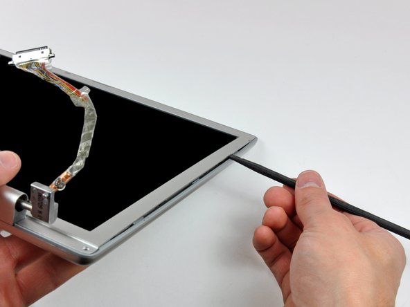Image 3/3: Work along the right edge of the display until the rear bezel is evenly separated from the front bezel.