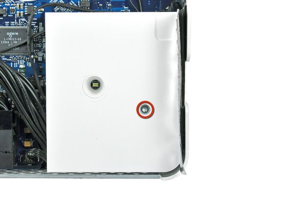 Image 1/2: Lift the right speaker out of the rear case and move it out of the way.