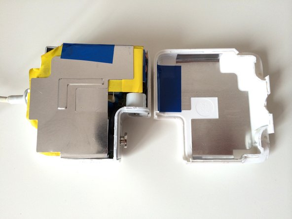 Image 2/2: Gently pull the two halves of the case apart.