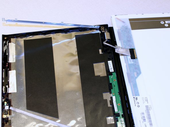 Image 1/3: Peel up the tape holding the connector but be careful not to damage the cable.