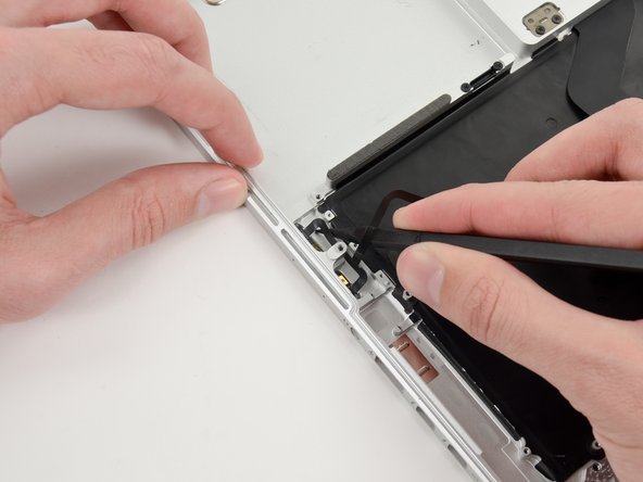 Image 3/3: Run the spudger up along the bottom of the microphone assembly cable to separate it from the upper case.