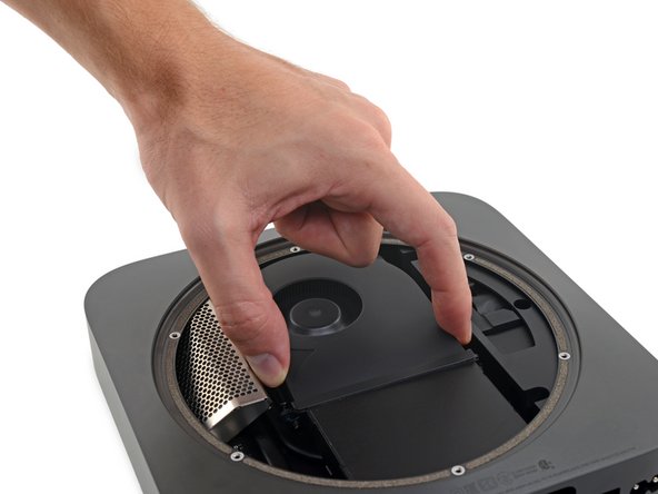 Don't try to remove the fan completely in this step—just lift it so you can access the cable underneath.