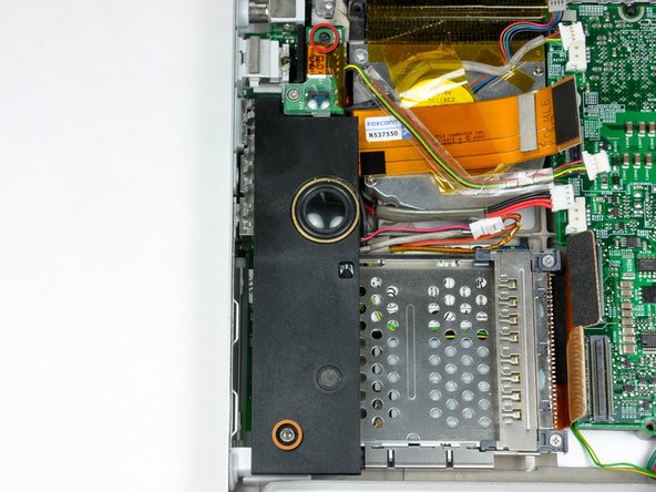 Image 1/2: Remove the 4 mm hex nut from the left speaker housing.