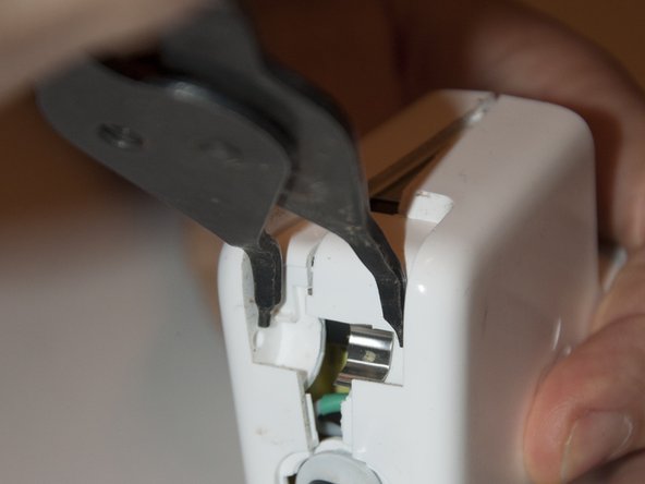 Image 2/3: Insert your pliers and pry slowly. (Make sure they stay seated in the inside corners, or you may injure yourself or gouge the case.)