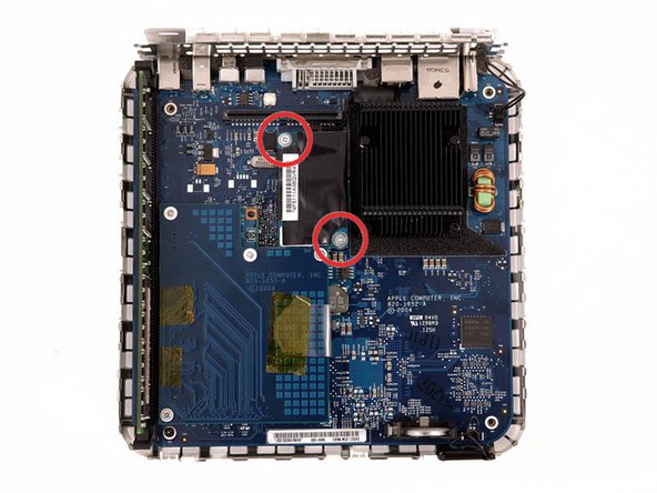 Remove the two silver Phillips screws from the corners of the modem board.