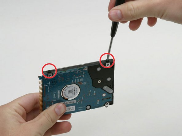 Image 1/1: With the pins facing away from you, and the label facing up, the bracket with a tab in the middle and a metal slot on it goes on the left side of the drive; the other bracket, of course, goes on the right.