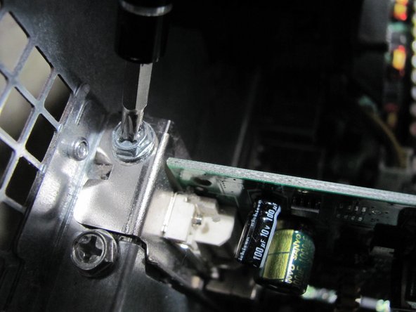 Image 1/1: Remove the 8.9 mm screw by using a Phillips #2 screw-driver.
