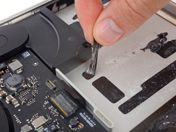 Before installing your new battery, remove all the old adhesive from the MacBook Pro's case.