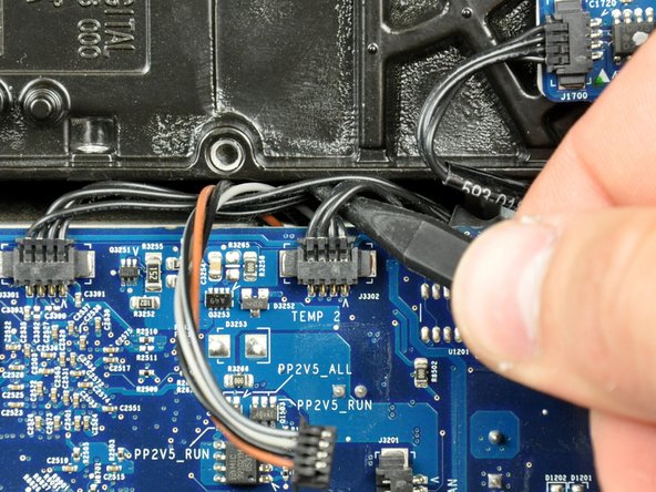 Image 1/2: Disconnect the optical drive temperature sensor connector from the logic board by pulling it straight away from its socket.