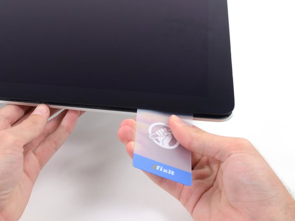 Image 2/2: As with the other side, twist slowly to allow the adhesive time to separate, and be careful not to over-stress the display glass.