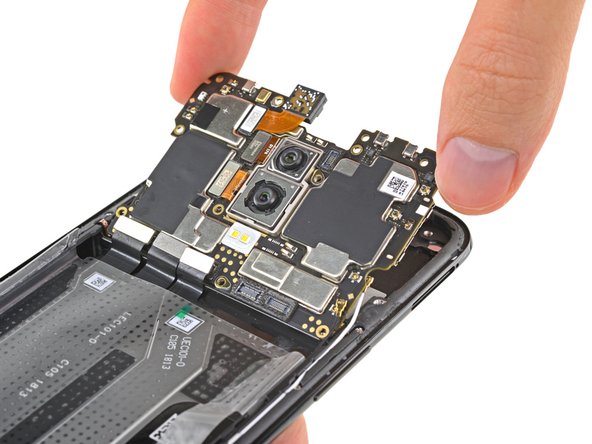 Having removed all the connectors tethering the motherboard to the phone, we slide it free and take a look at what chips it holds: