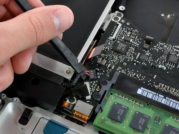 Image 1/1: Using the flat end of a spudger, pry the subwoofer connector straight up off its socket on the logic board.