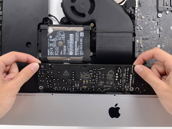 Image 2/2: Tilt the power supply forward.